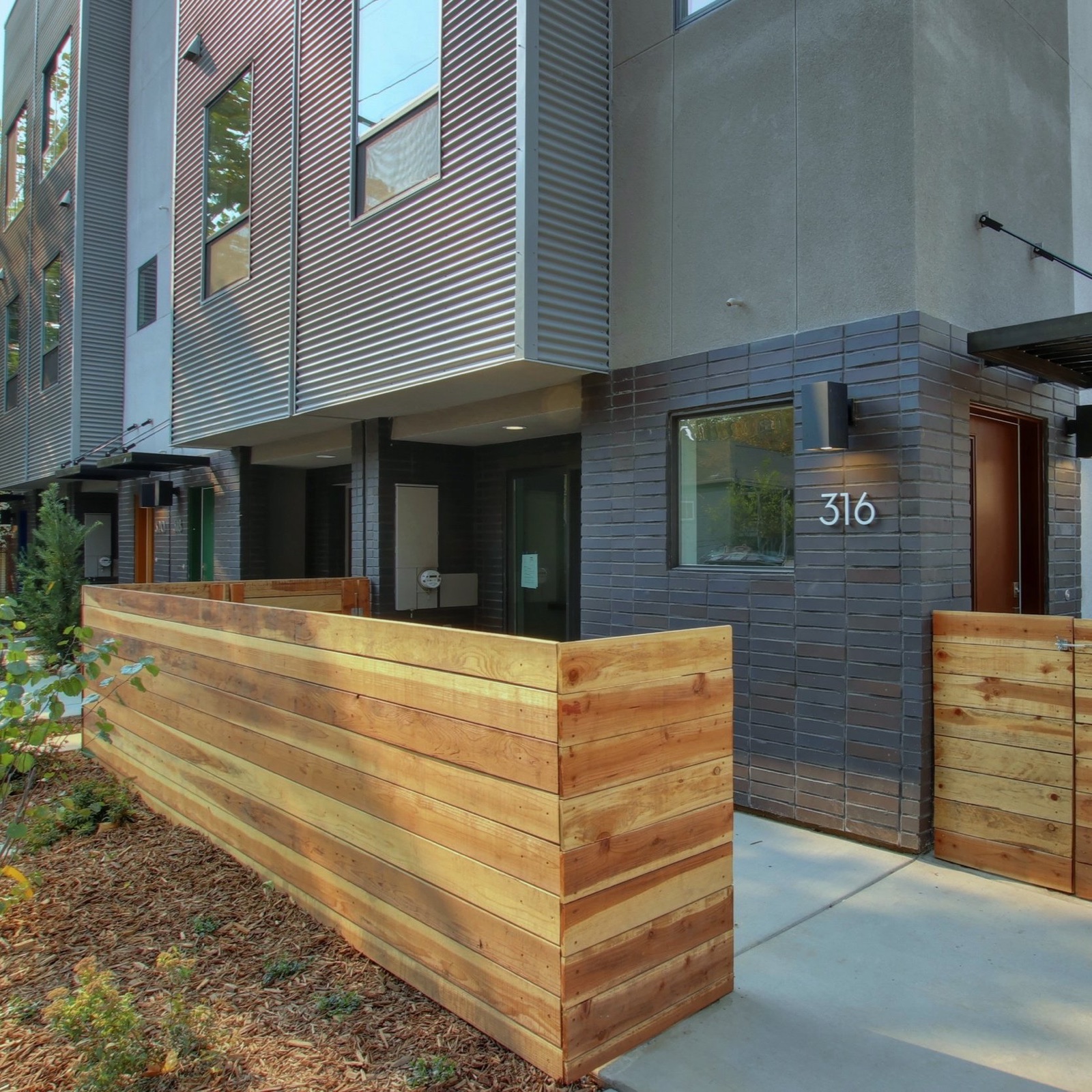 14C Lofts entry with cedar fence and brick